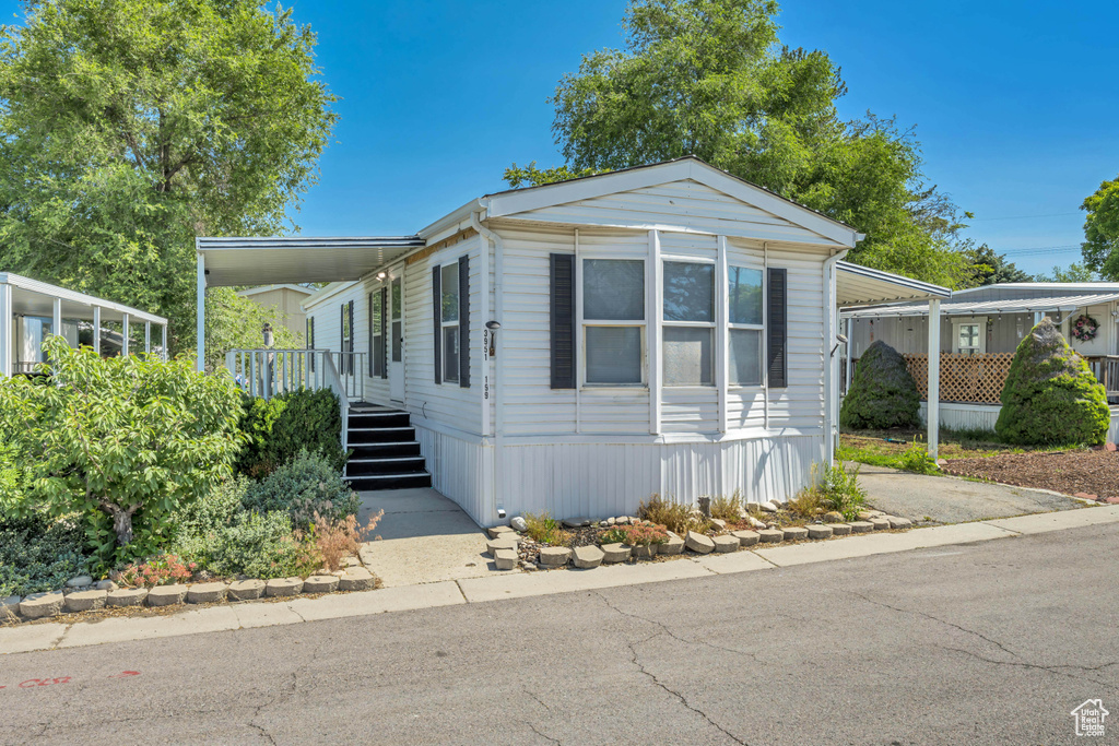 Manufactured / mobile home with an attached carport and a porch