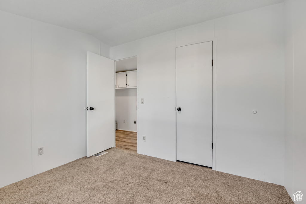 Unfurnished bedroom with carpet