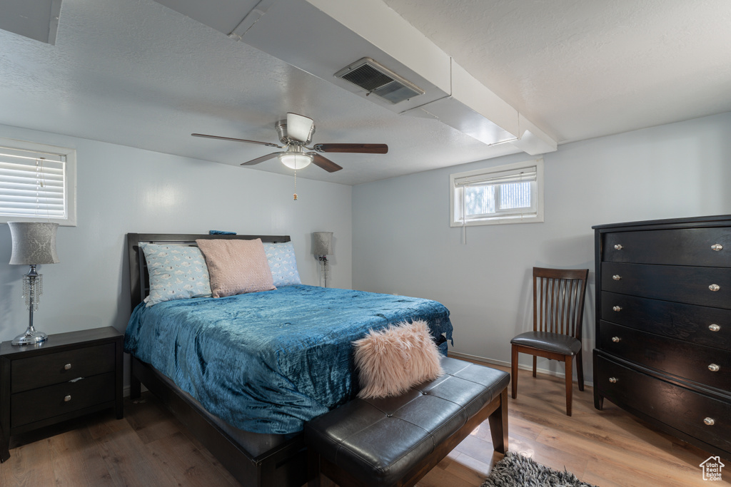 Bedroom with wood finished floors, a ceiling fan, and baseboards