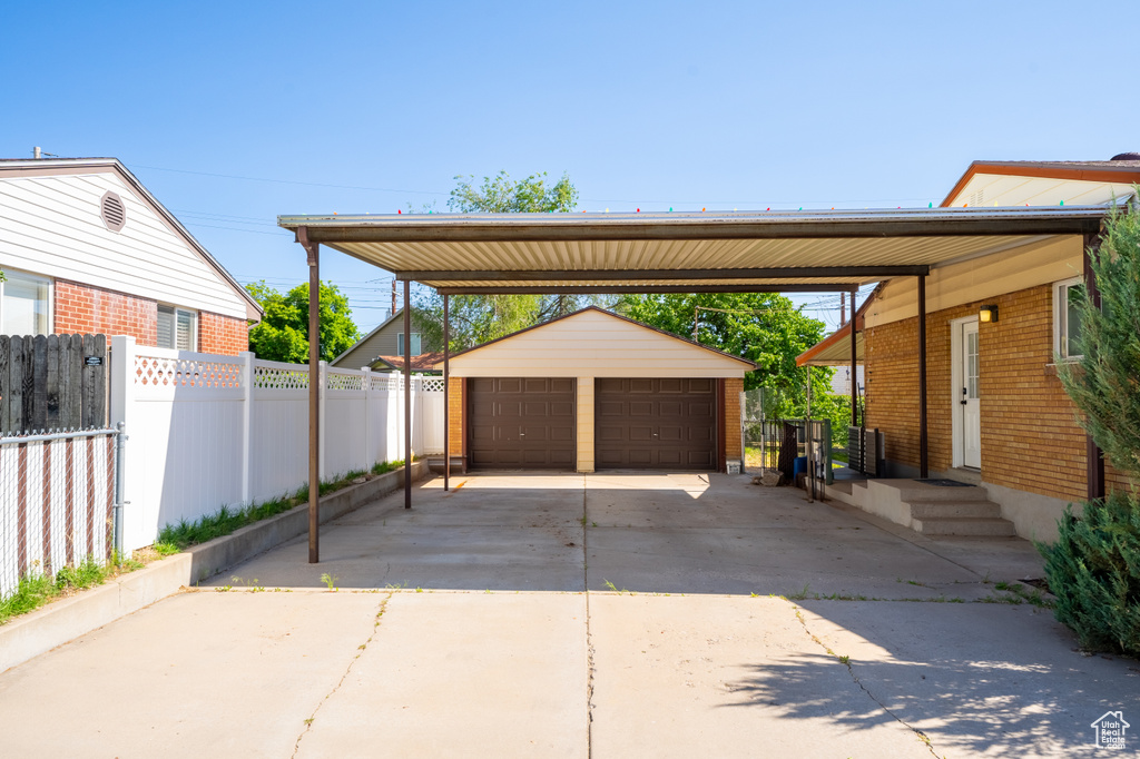 View of car parking with a detached garage