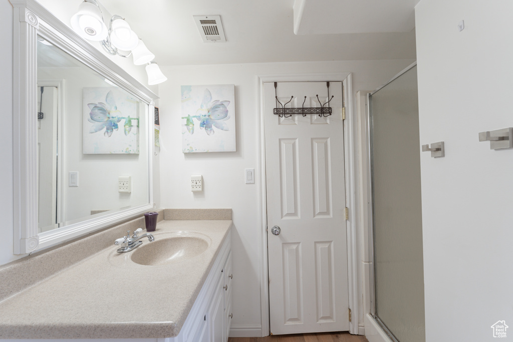 Bathroom with vanity and a stall shower