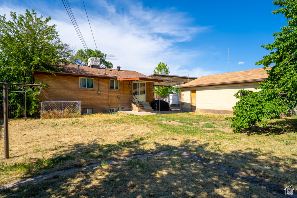 Back of house with a patio, entry steps, and brick siding