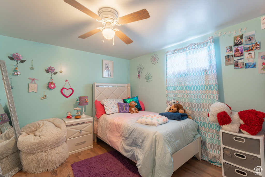 Bedroom with wood finished floors and a ceiling fan