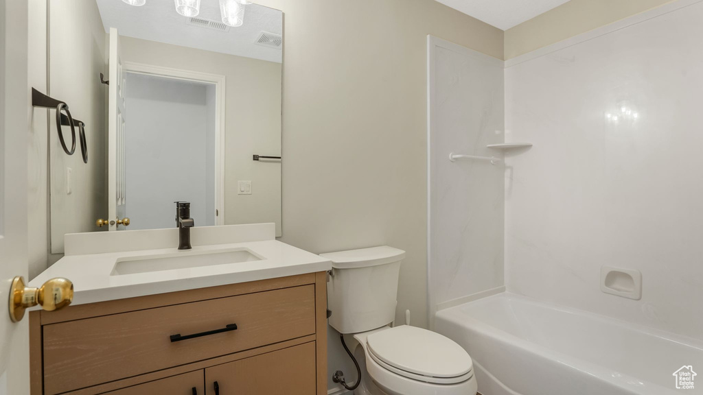 Bathroom with toilet, vanity, and bathing tub / shower combination