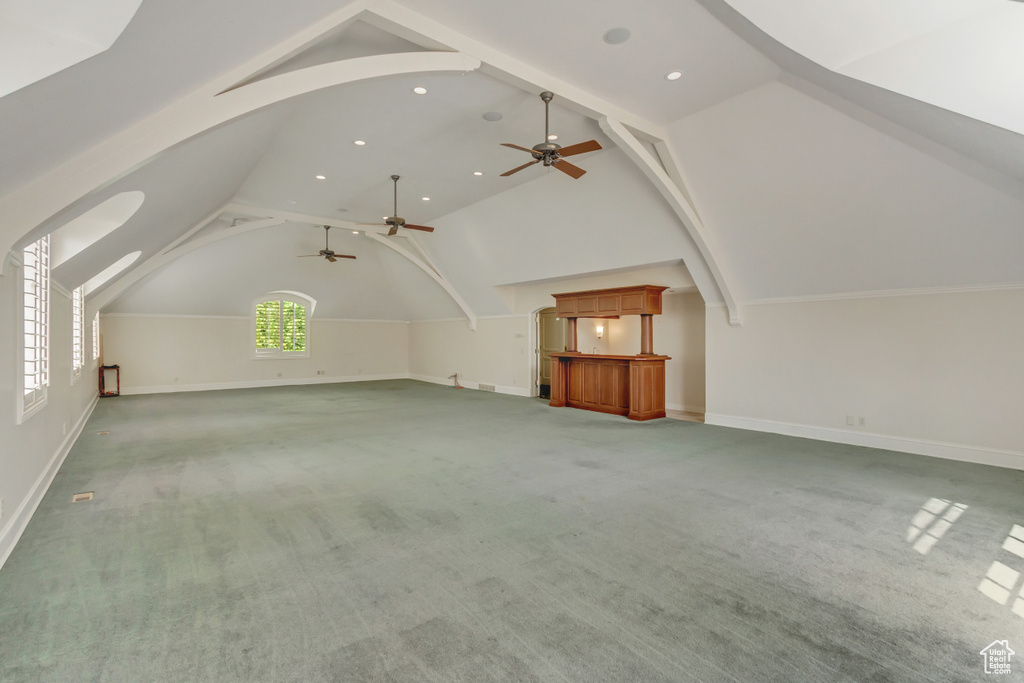 Additional living space featuring ceiling fan, carpet, and vaulted ceiling