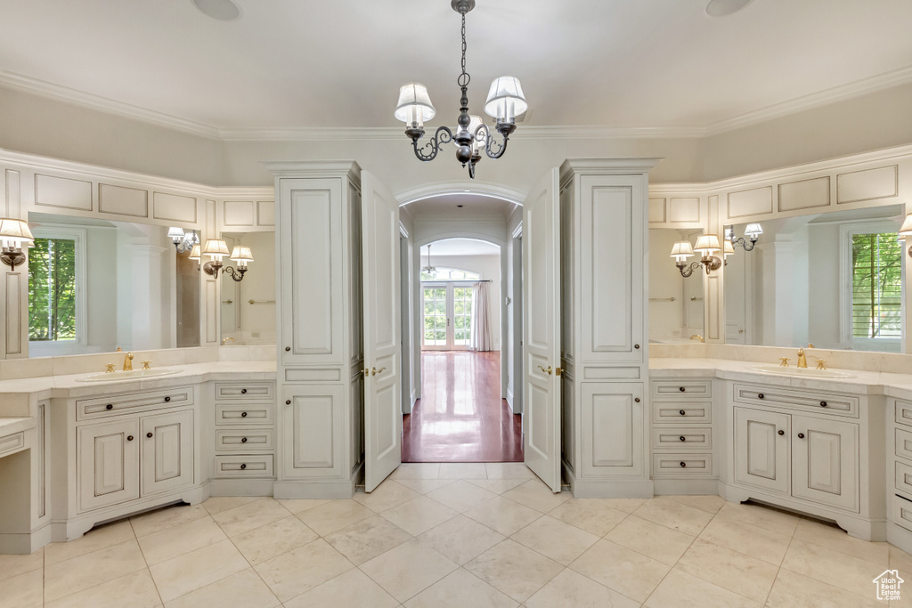 Bathroom with a wealth of natural light, ornamental molding, and hardwood / wood-style flooring