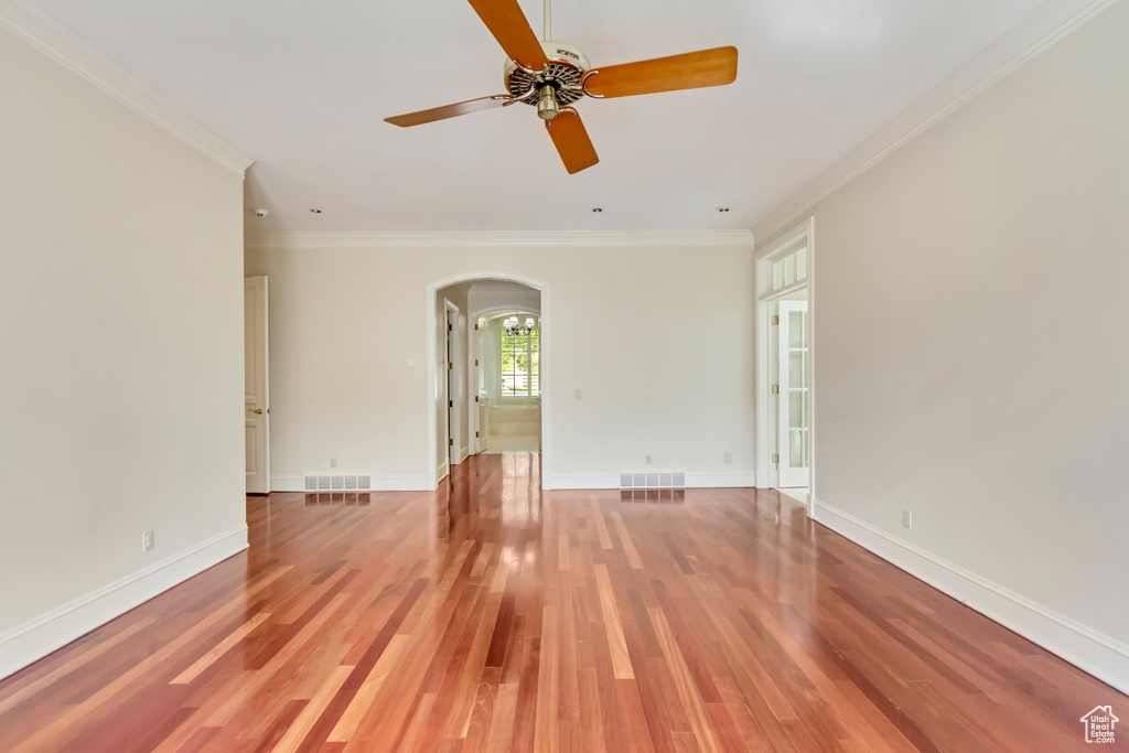 Spare room featuring ornamental molding, hardwood / wood-style floors, and ceiling fan