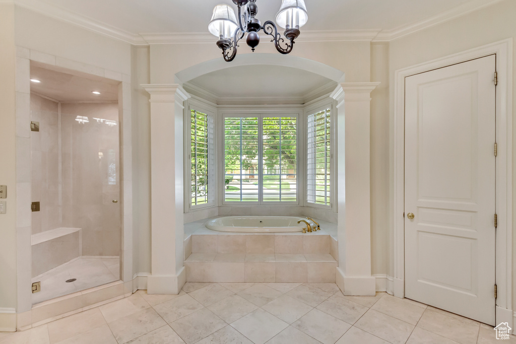 Bathroom with ornamental molding, tile patterned floors, and a chandelier