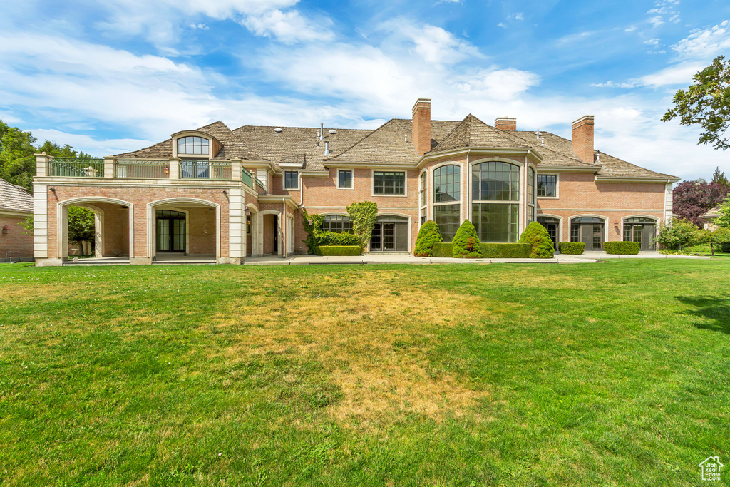 French provincial home featuring a front yard