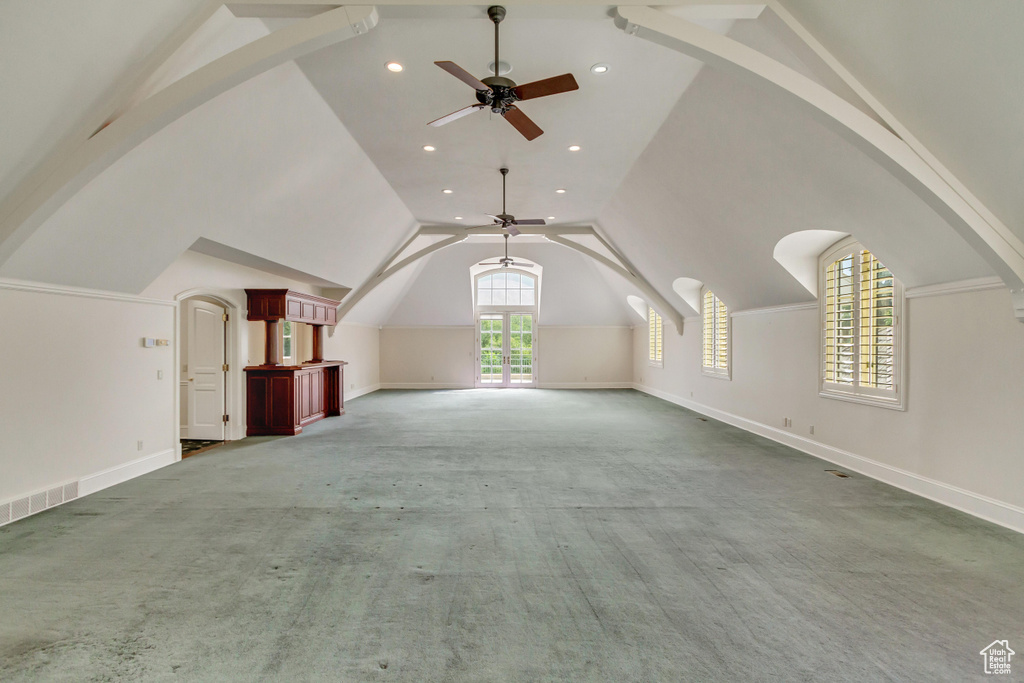 Bonus room featuring ceiling fan, high vaulted ceiling, and carpet flooring