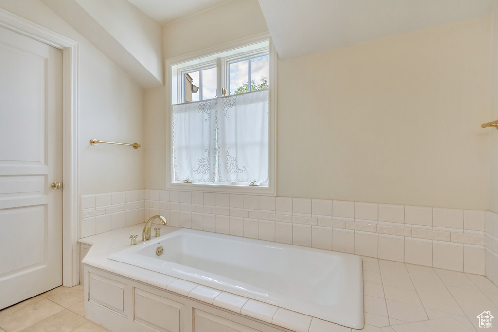 Bathroom featuring a tub to relax in and tile patterned flooring