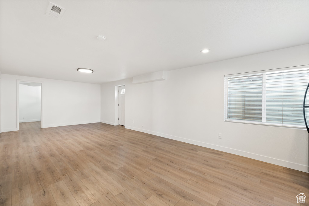 Unfurnished room featuring baseboards, light wood finished floors, and recessed lighting