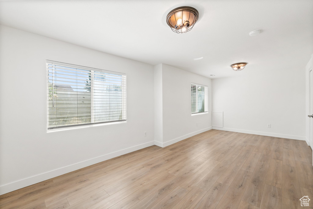 Spare room with light wood-style floors and baseboards