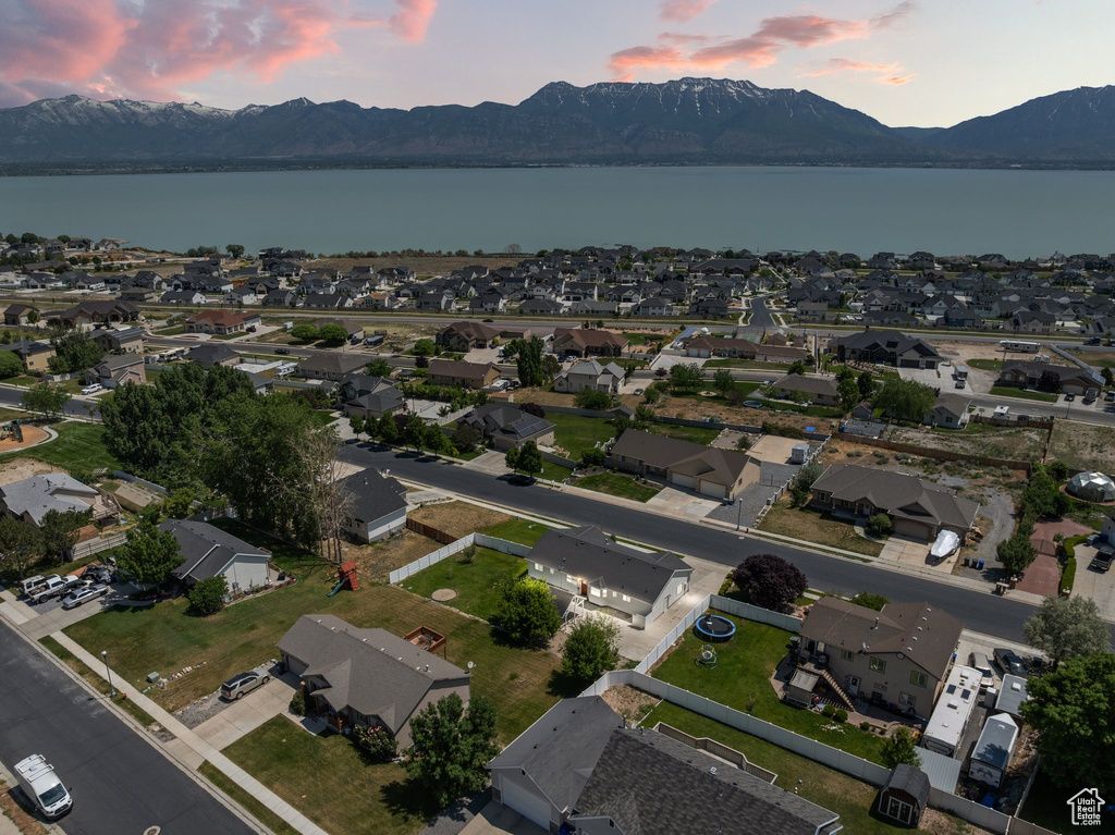 View of property location featuring a water and mountain view and nearby suburban area