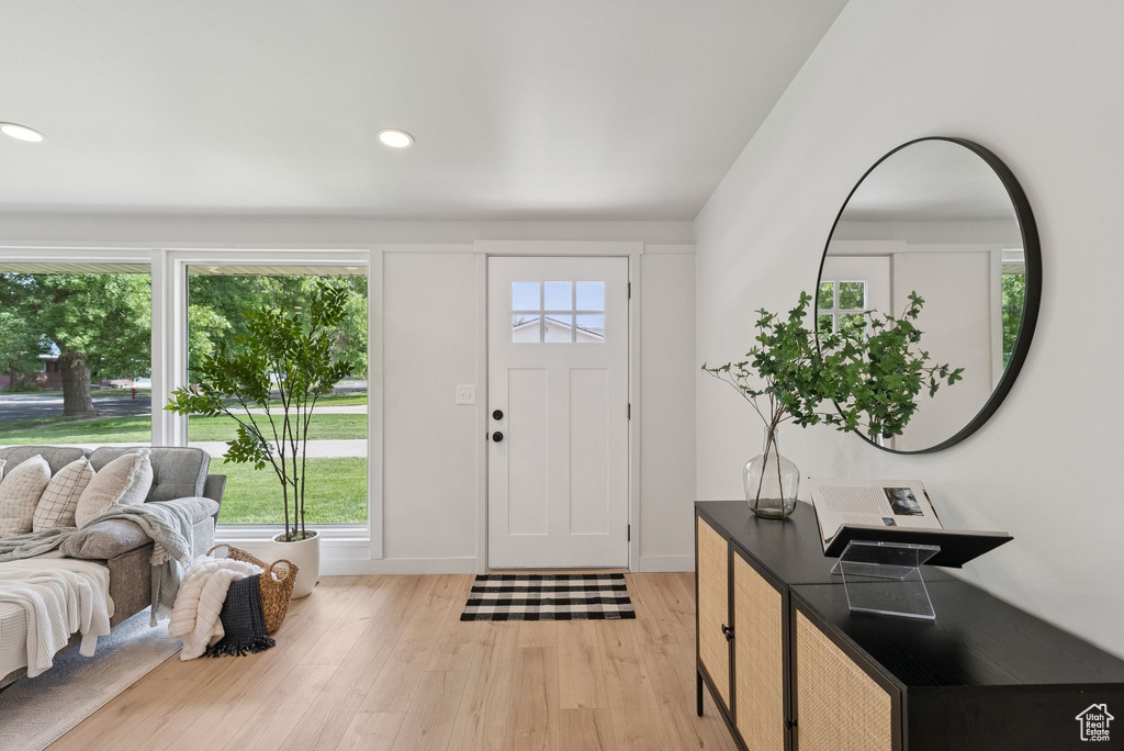 Entrance foyer with light wood-style flooring, recessed lighting, and baseboards
