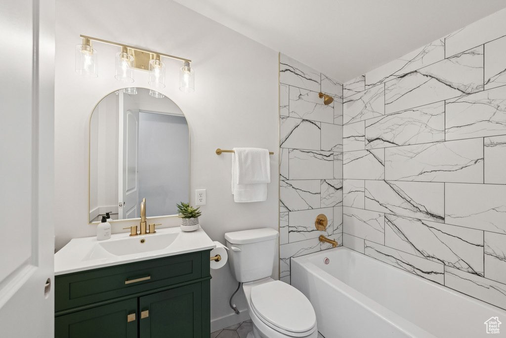 Bathroom featuring vanity, toilet, and tub / shower combination
