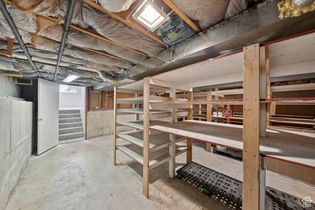 Unfinished below grade area featuring stairs