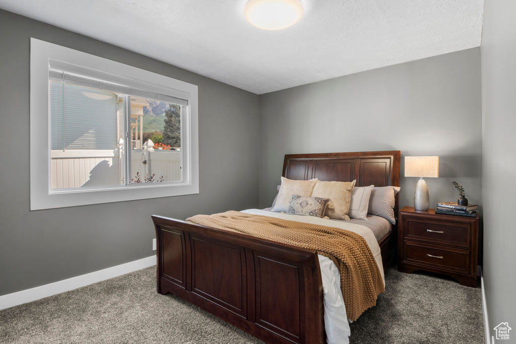 Bedroom with carpet flooring and baseboards