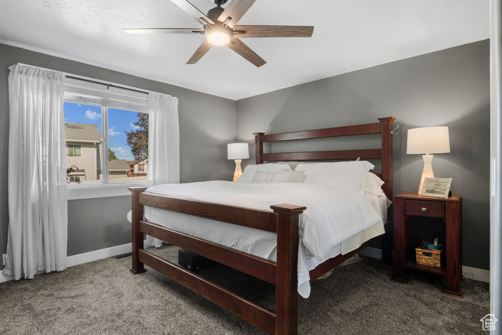 Bedroom with carpet floors, ceiling fan, and baseboards