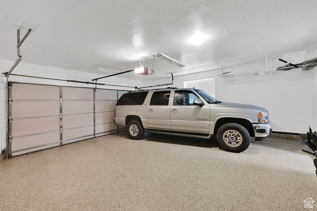 Garage featuring a garage door opener