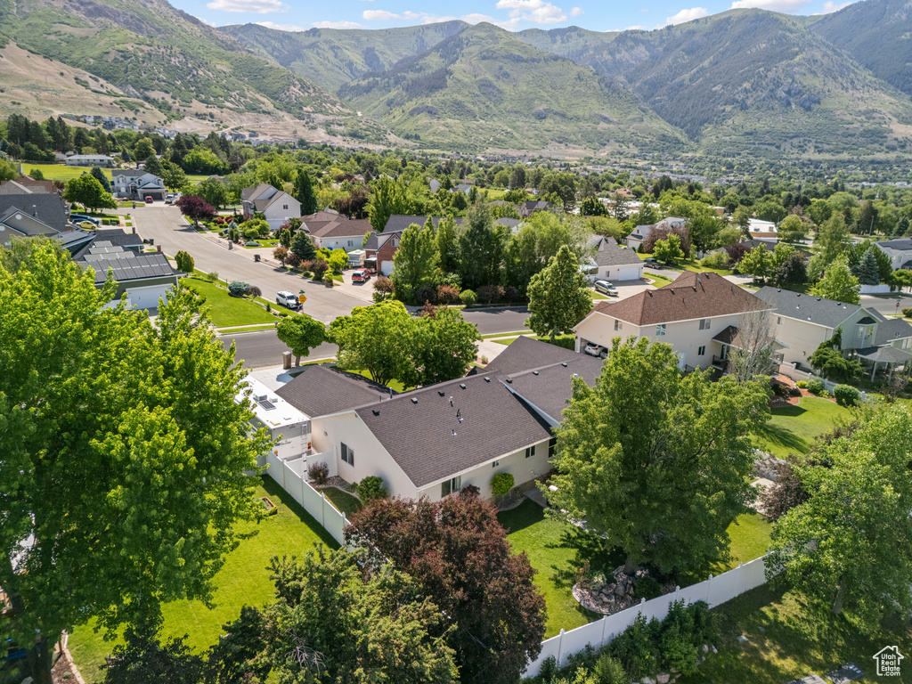 Aerial view of property and surrounding area featuring nearby suburban area and mountains