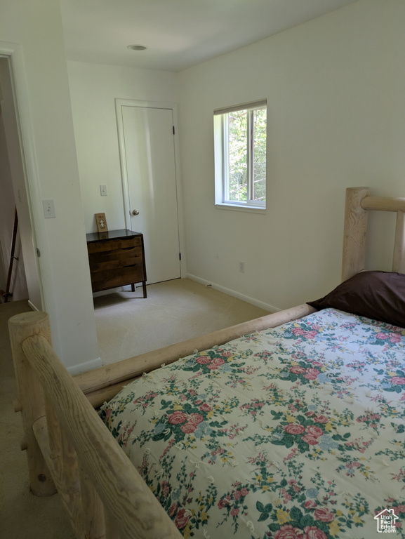 Bedroom with carpet floors and baseboards