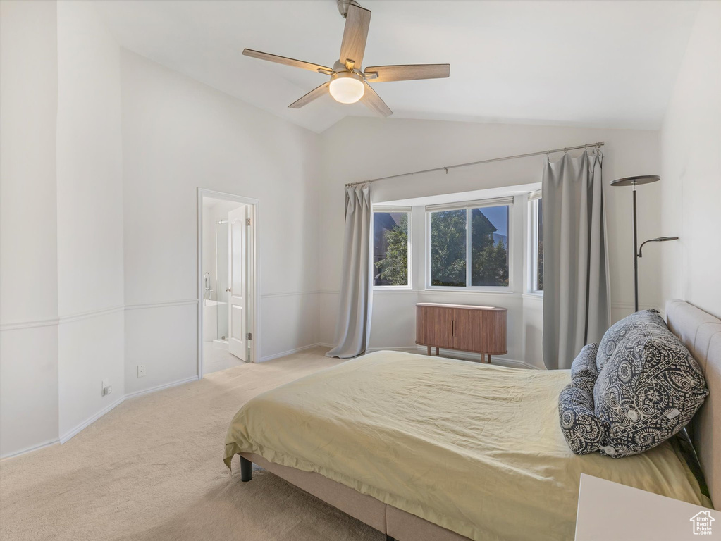 Bedroom featuring vaulted ceiling, carpet floors, baseboards, a ceiling fan, and connected bathroom
