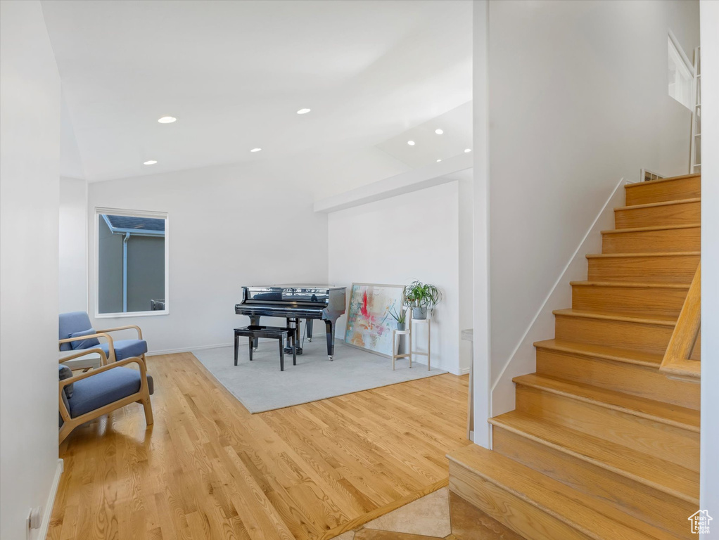 Foyer with stairway, lofted ceiling, wood finished floors, baseboards, and recessed lighting