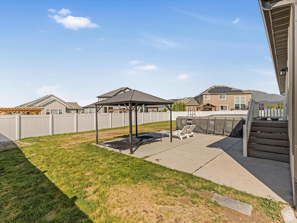 View of yard with a gazebo, a patio area, and a residential view