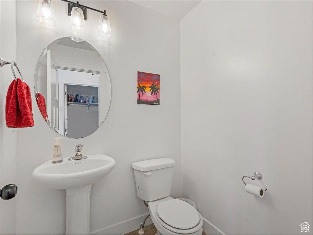 Bathroom featuring toilet and baseboards