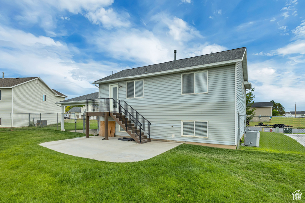 Back of property with a patio, central AC, stairs, and a shingled roof