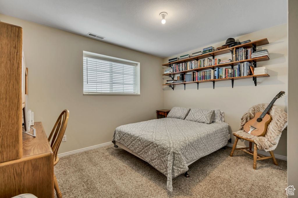 Carpeted bedroom with baseboards
