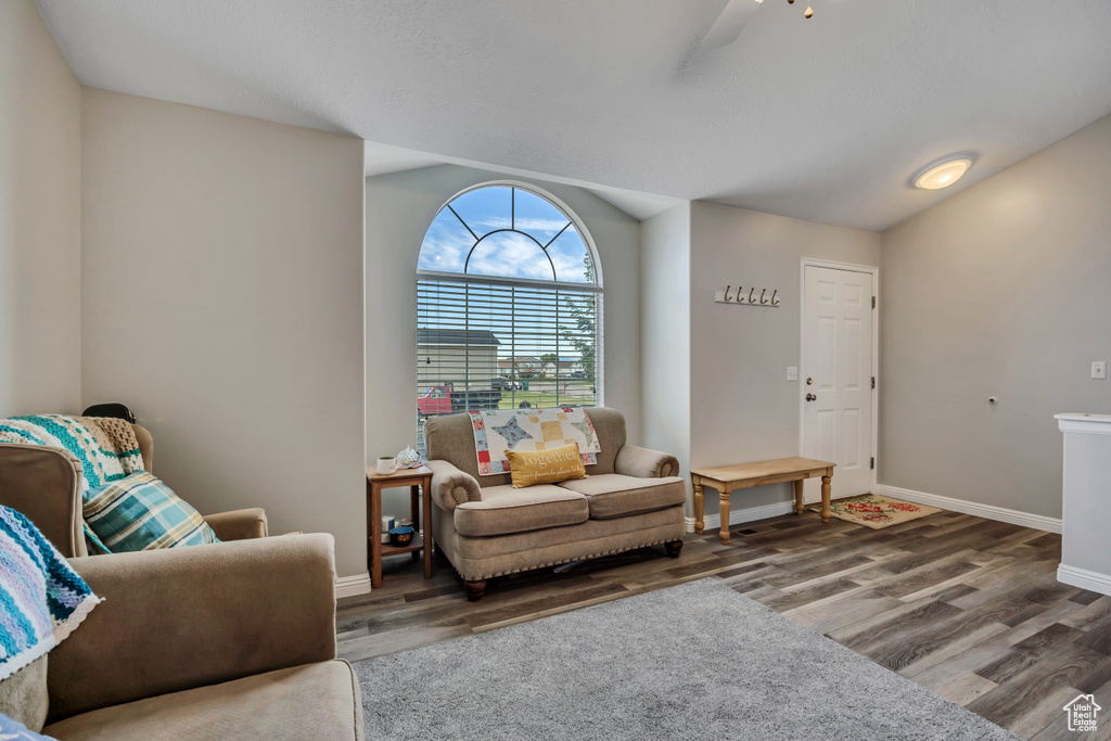 Living room featuring wood finished floors, baseboards, and ceiling fan