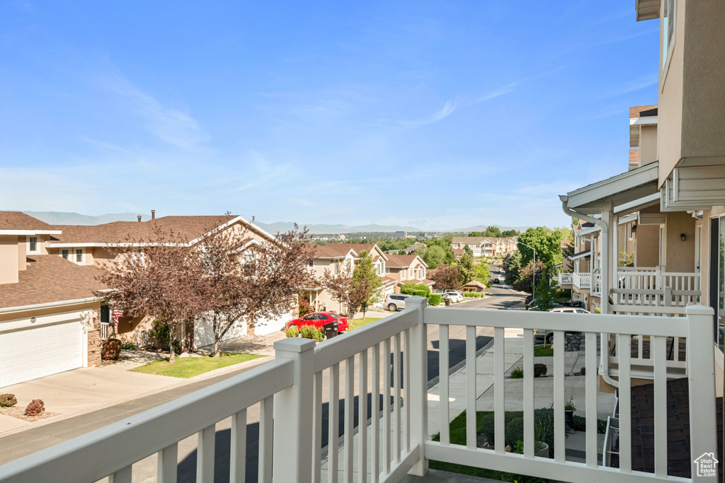 Balcony featuring a residential view and a mountain view
