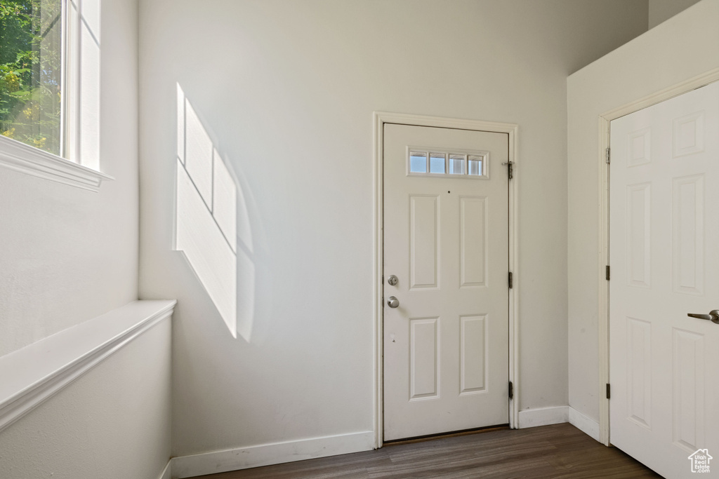 Foyer featuring dark wood-type flooring and baseboards