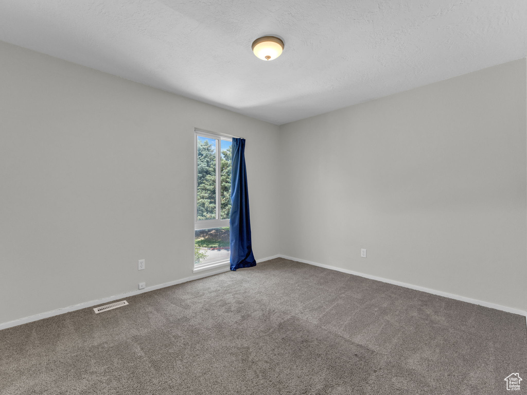 Unfurnished room with carpet floors and baseboards