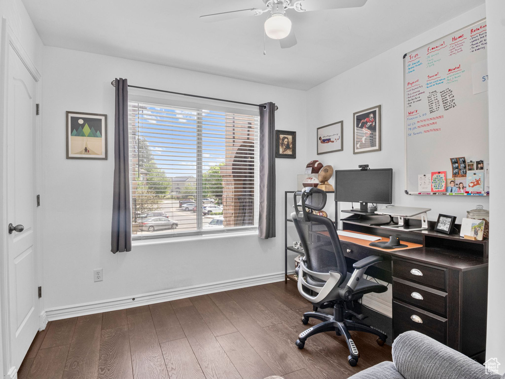 Office area featuring a ceiling fan, dark wood-style floors, and baseboards