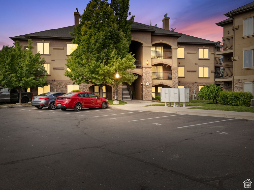 View of building exterior with uncovered parking