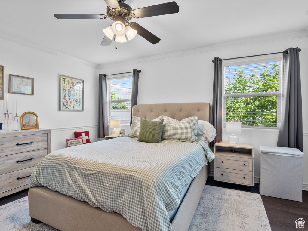 Bedroom featuring crown molding, wood finished floors, and ceiling fan