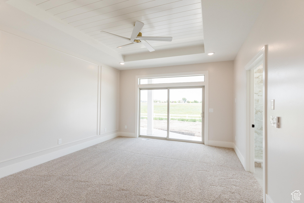 Unfurnished room with light carpet, ceiling fan, baseboards, and wood ceiling