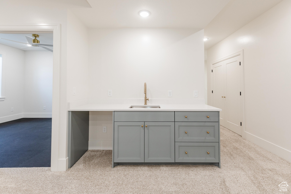 Bar featuring a sink, light carpet, a ceiling fan, baseboards, and recessed lighting