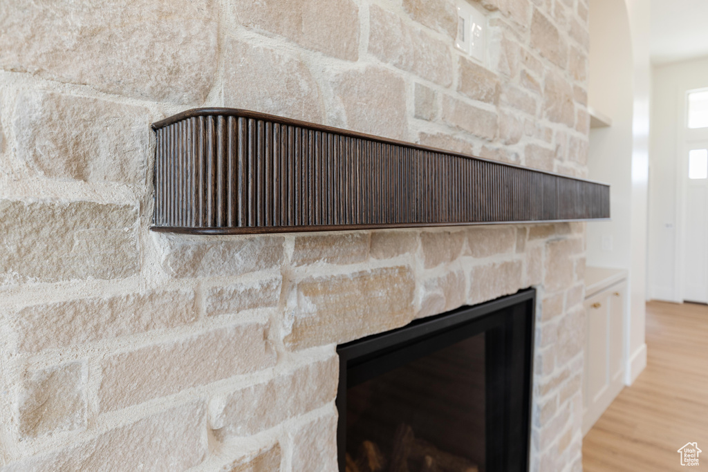 Detailed view of wood finished floors and a fireplace