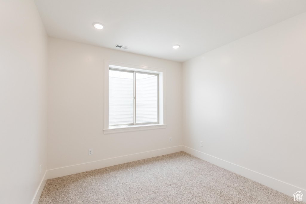 Unfurnished room with baseboards, light colored carpet, and recessed lighting
