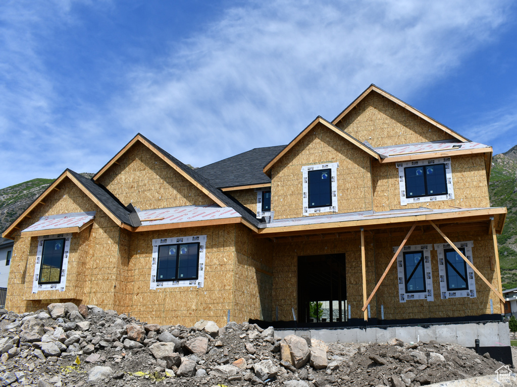 Property in mid-construction featuring a standing seam roof, a mountain view, metal roof, and covered porch