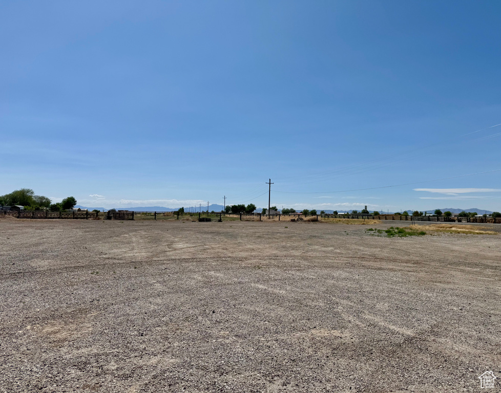 View of yard with a rural view and a mountain view
