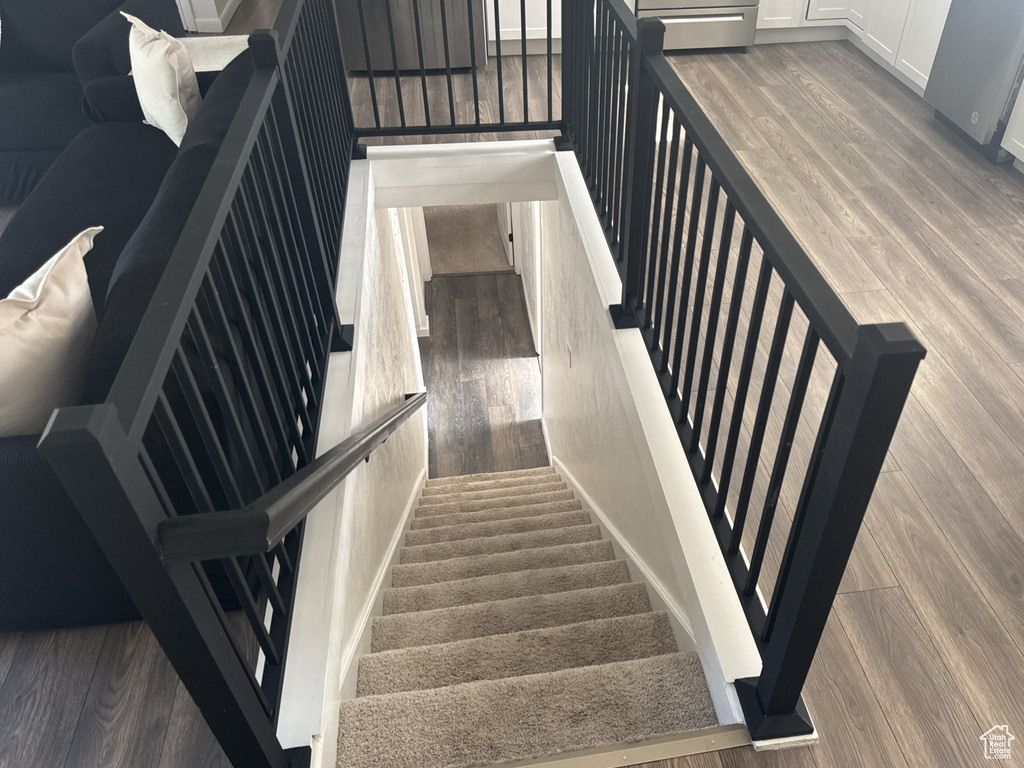 Stairs featuring wood finished floors