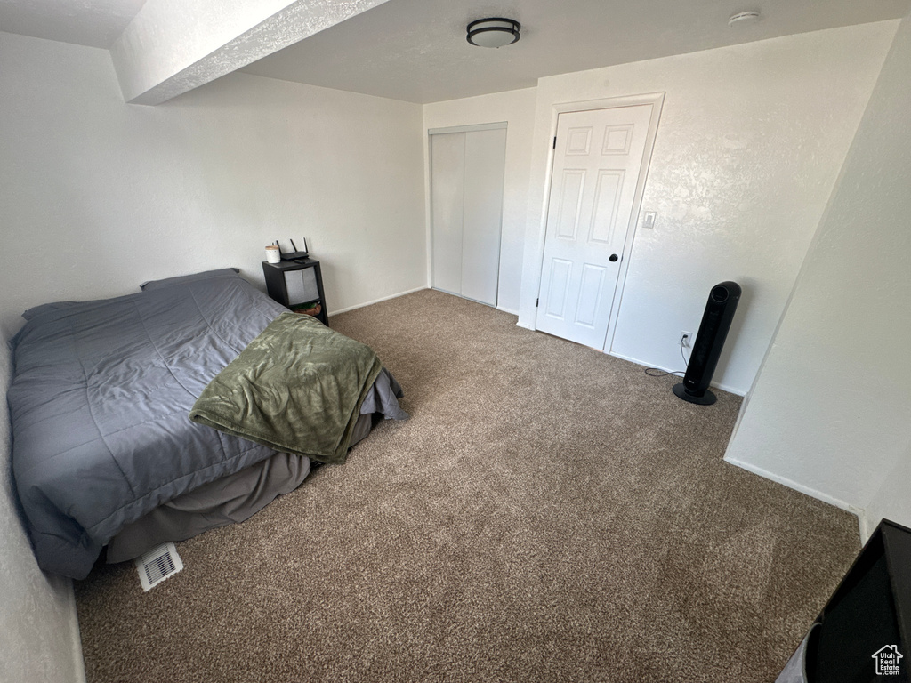 Bedroom with carpet and a closet
