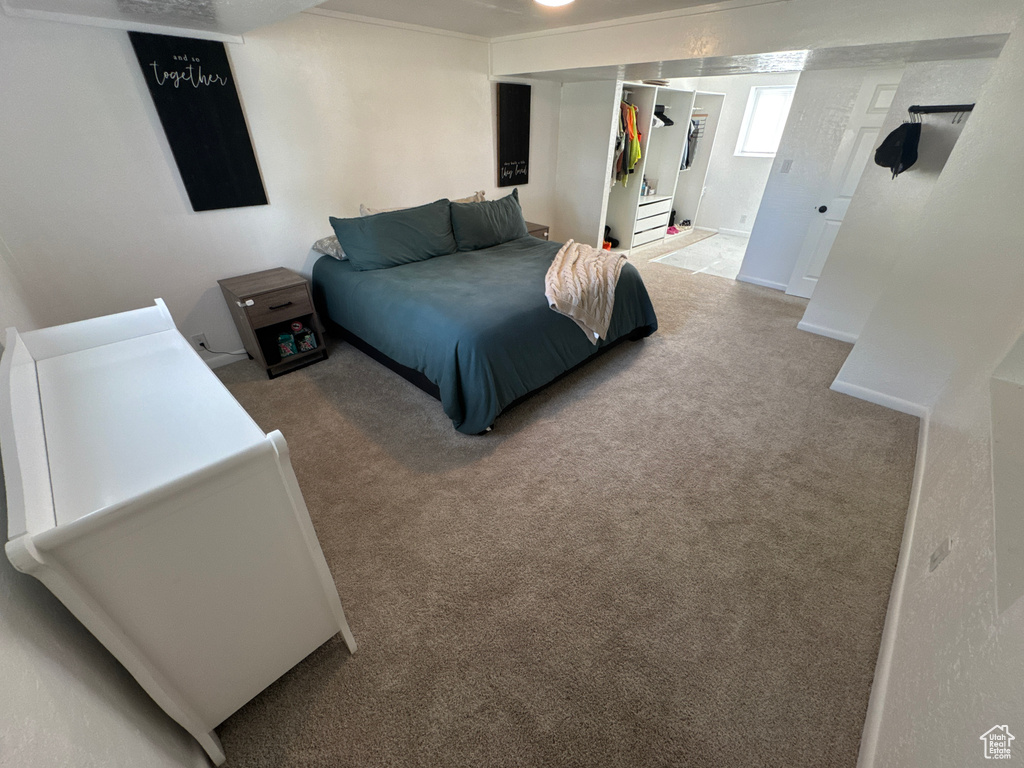 Bedroom featuring carpet flooring and a closet