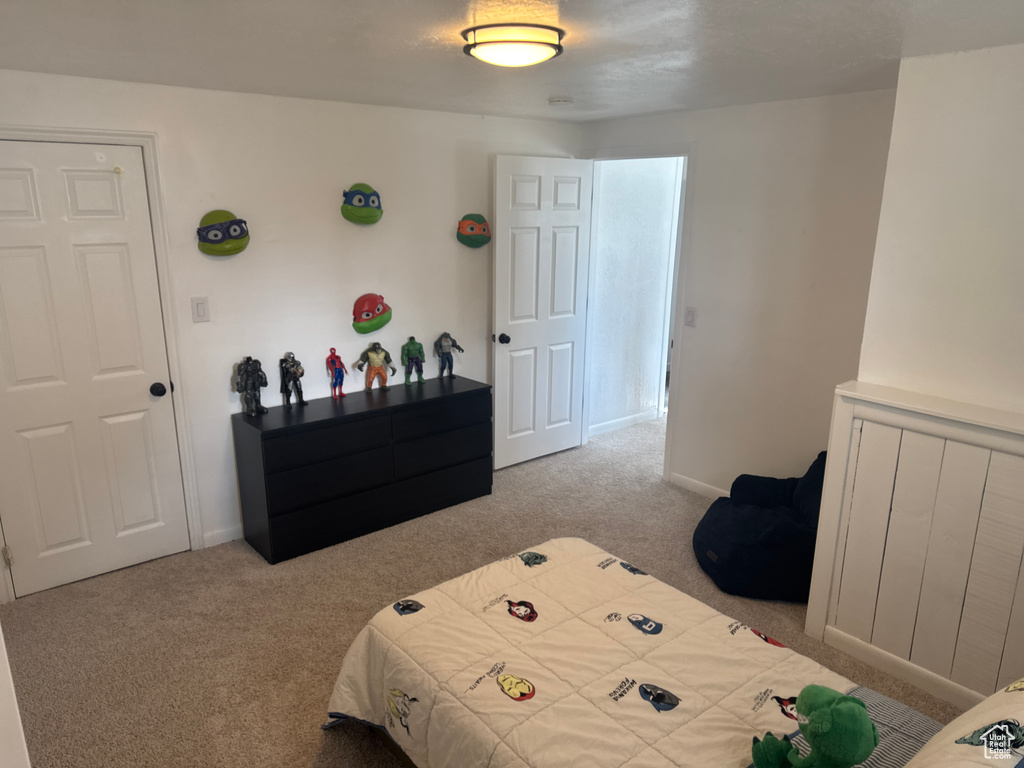 Bedroom with carpet flooring and baseboards