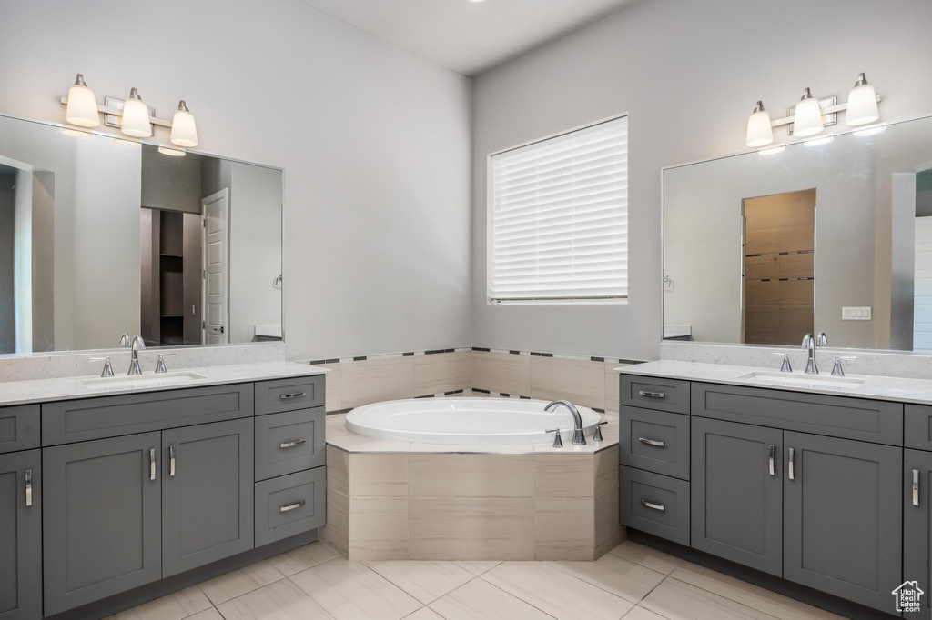 Full bath with two vanities and a bath